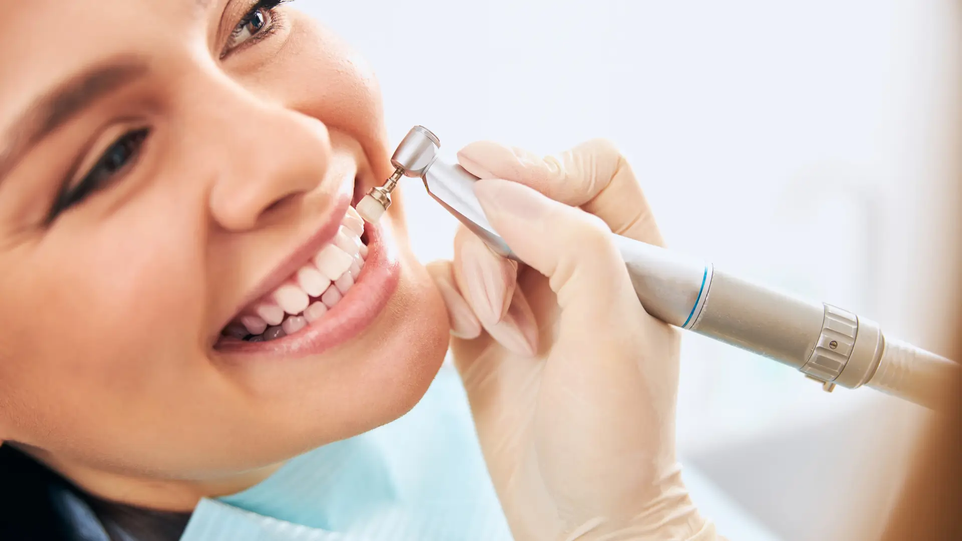 A woman is holding a tooth brush and smiling.