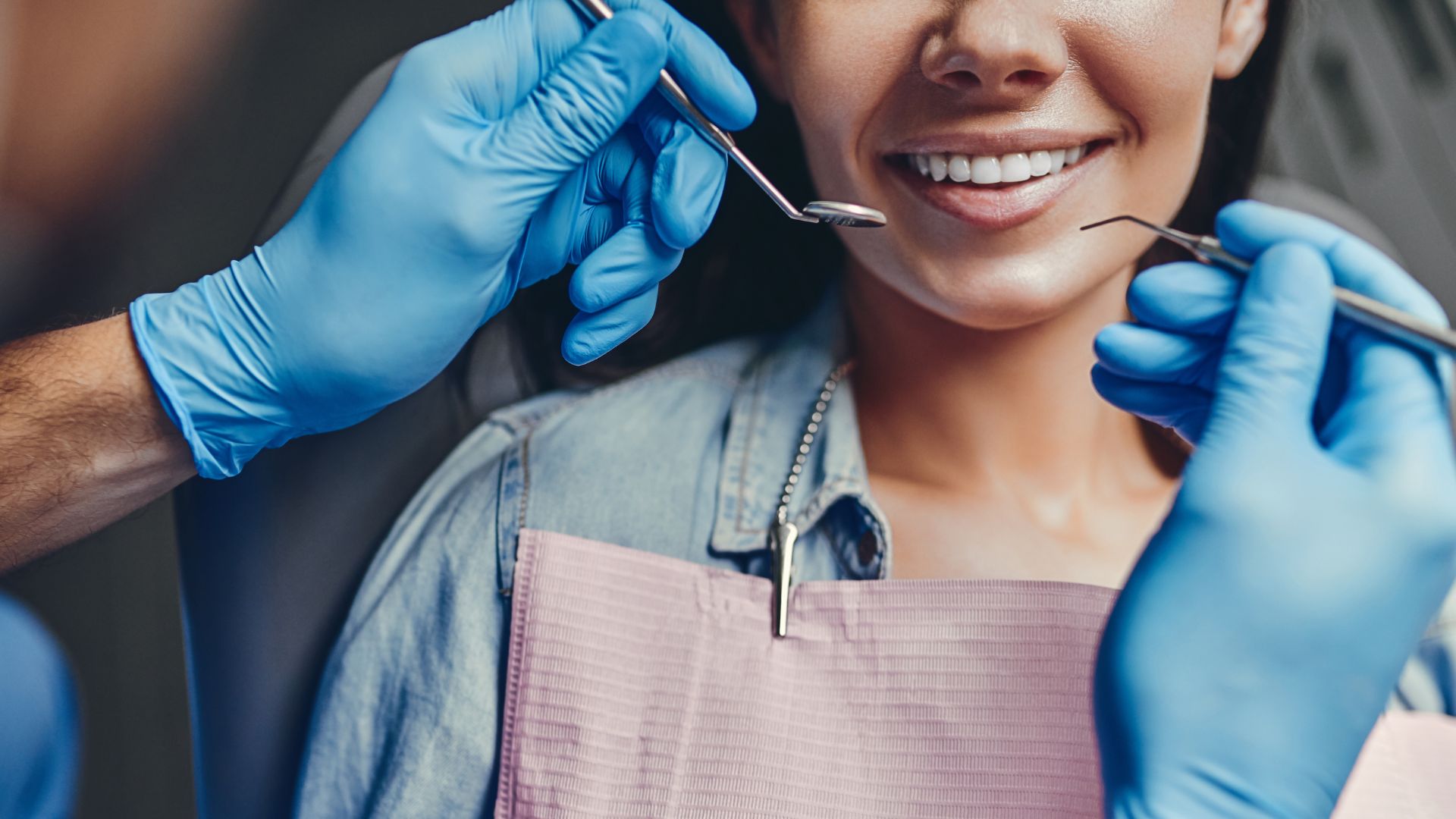 Dental checkup with patient and dentist tools.