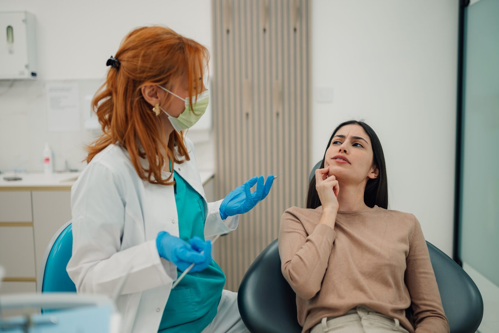 Dentist talking a patient through gum treatment options at a consultation
